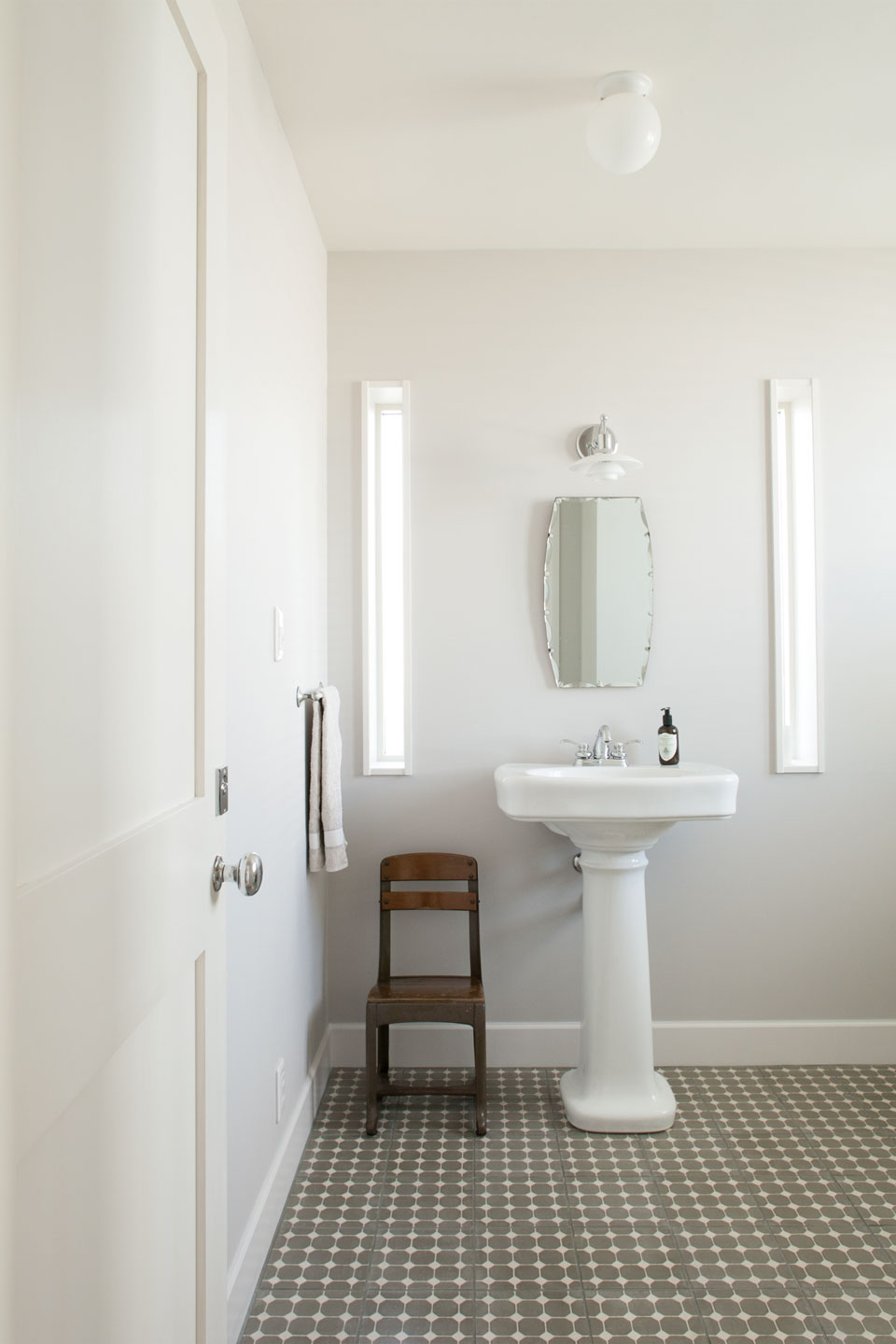 ポルトガルから輸入したタイルを敷いたトイレ。ホワイトペイントとの調和で柔らかい雰囲気に包まれている。